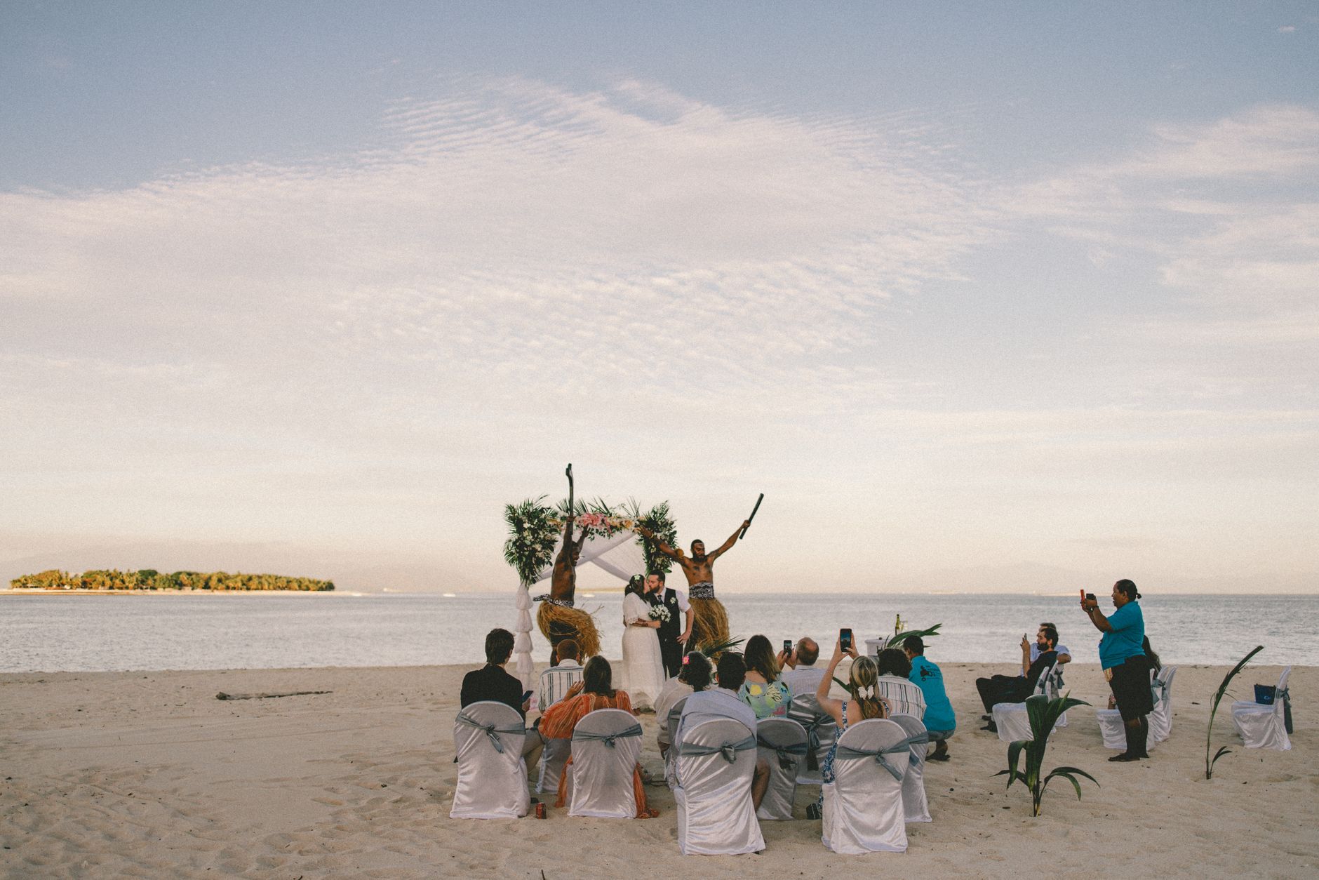 Experience a stunning beach wedding ceremony with scenic ocean views in Fiji.