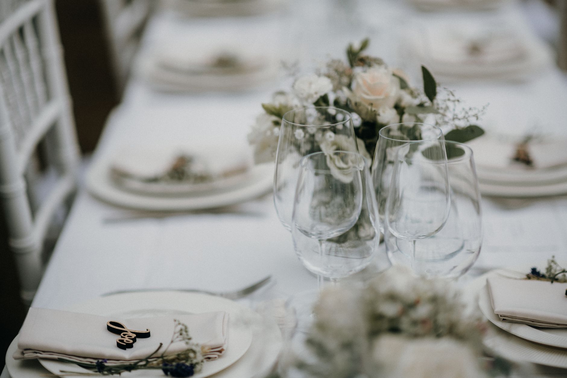 A beautifully arranged table with floral decor and glassware, perfect for a stylish event.