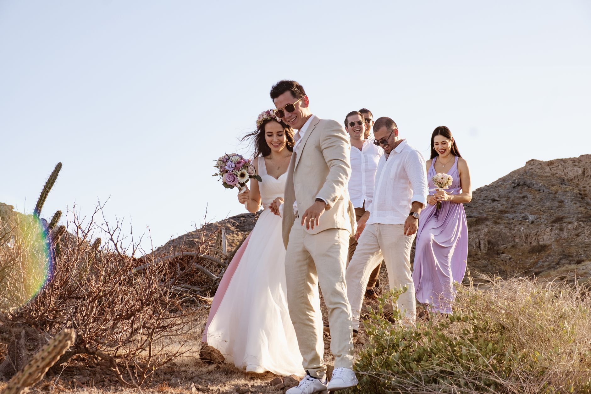 Beautiful candid photo of a wedding party on the beach in La Paz, Mexico at sunset.
