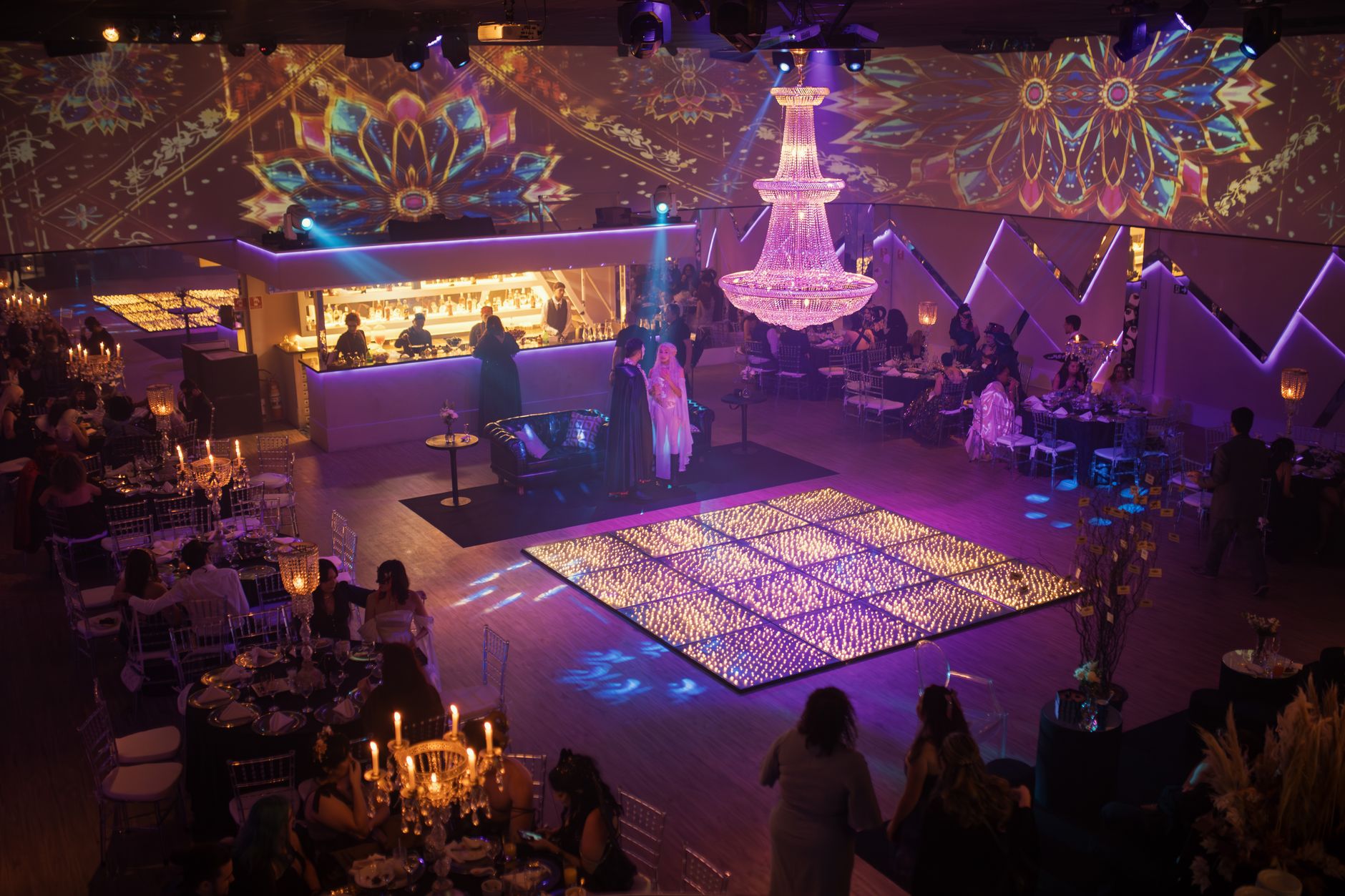 Elegant indoor party with vibrant lighting and luxurious decor, capturing a festive atmosphere.