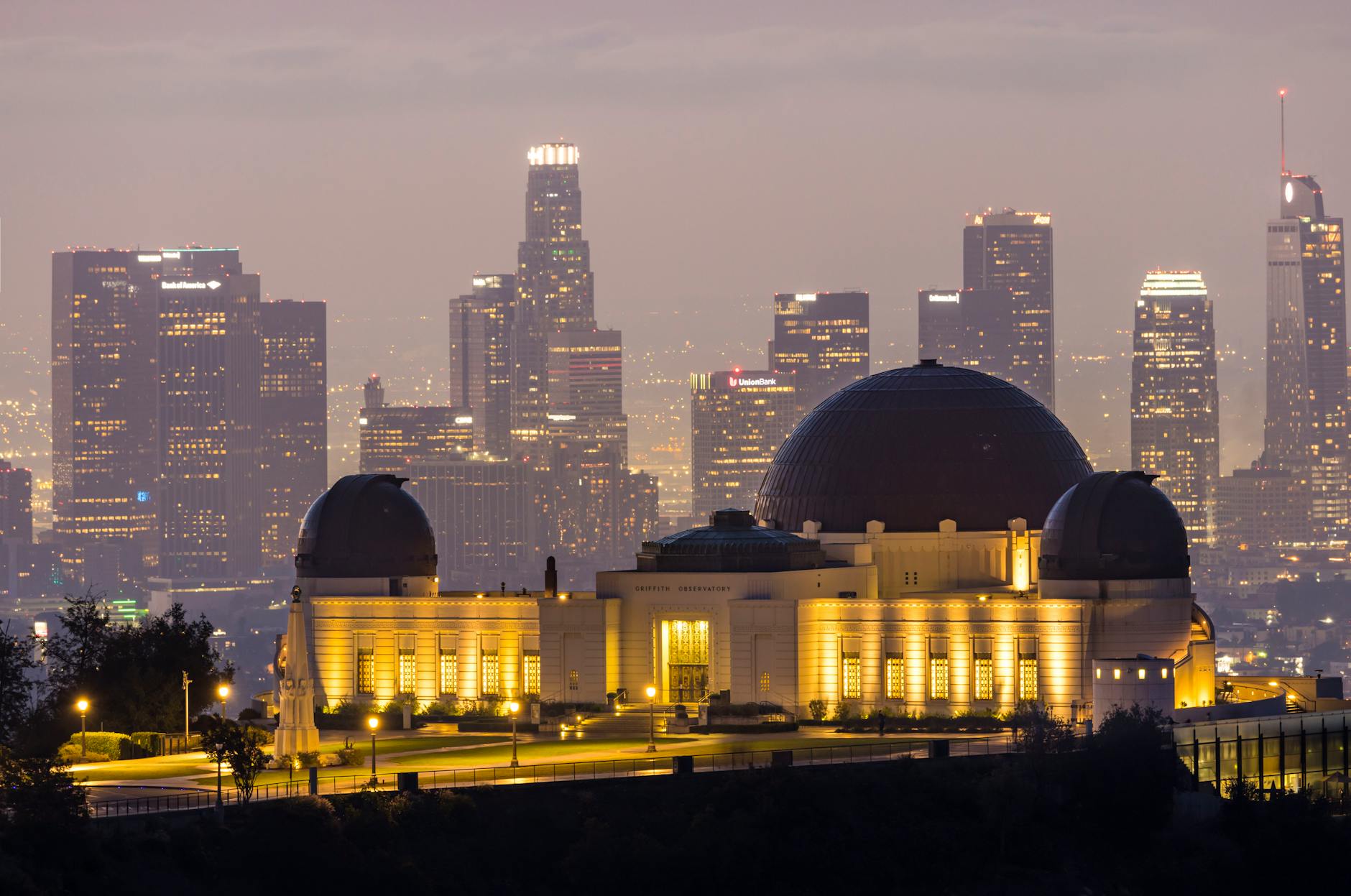 Griffith Observatory against the Los Angeles skyline during twilight, showcasing city lights and architectural beauty.