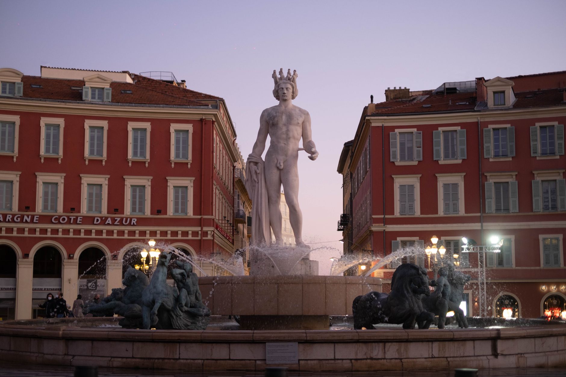 Explore the stunning Fontaine du Soleil in Nice, France, captured at twilight in Place Masséna.