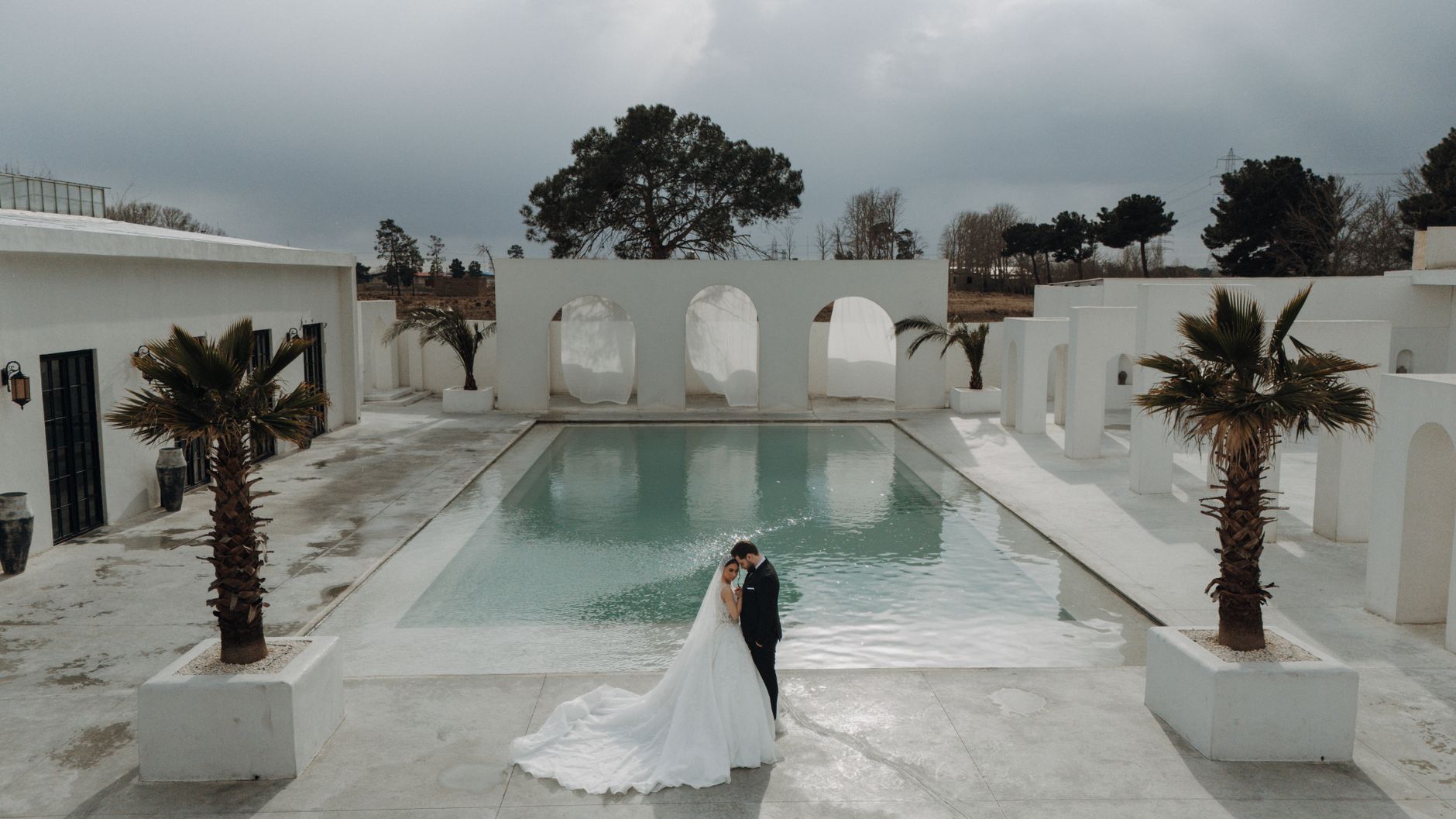 A stunning outdoor wedding with a couple by the pool in Tehran, Iran. Perfect for summer wedding themes.