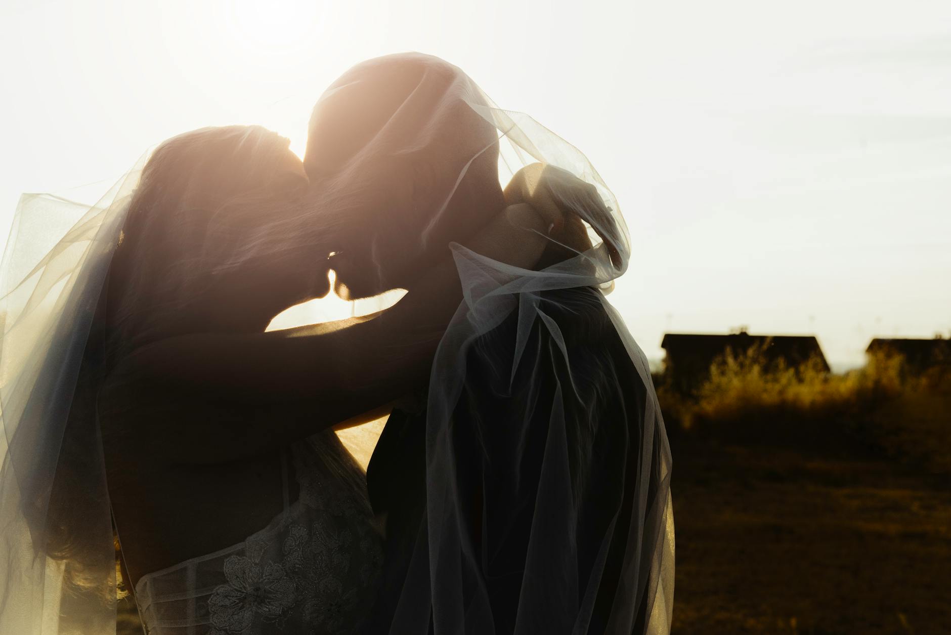 Bride and groom share a kiss during a beautiful sunset wedding in Spain.