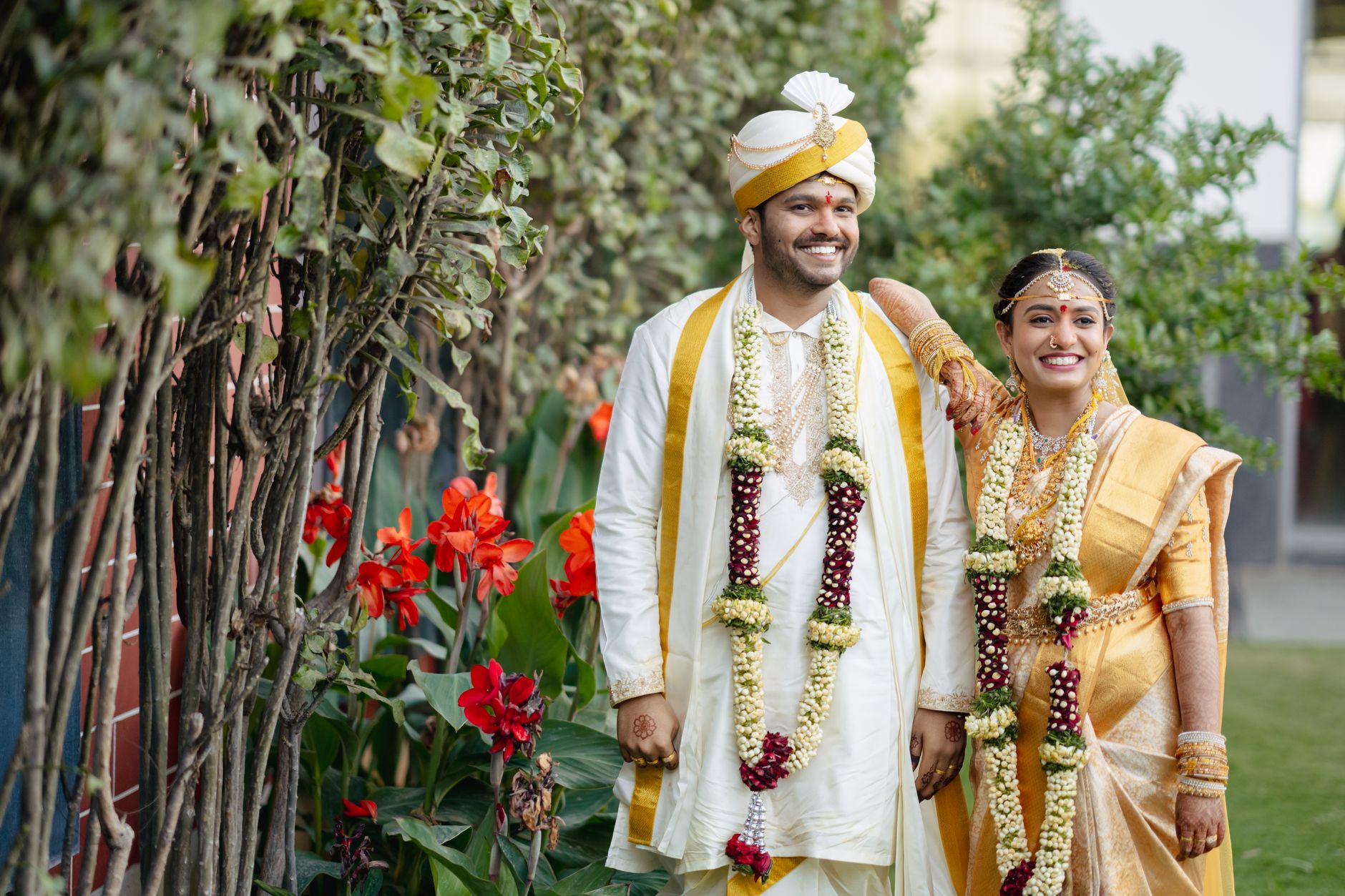 A joyful Indian couple in traditional attire captured during their wedding in Hyderabad, India.