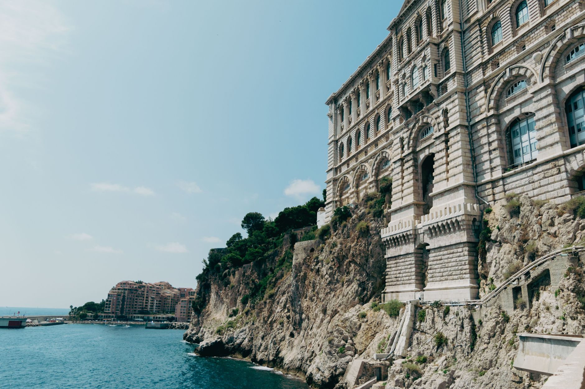 Explore the stunning cliffside architecture of Monaco in a bright summer view.