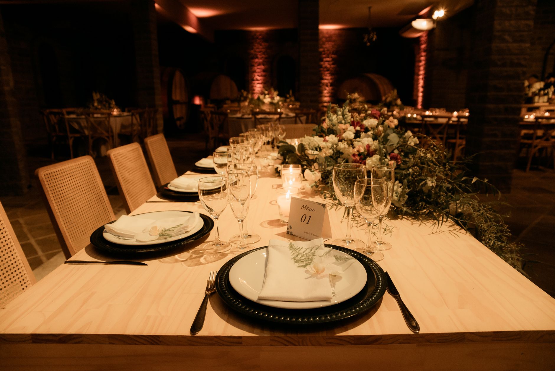 Beautifully decorated dinner table with floral centerpiece, ideal for weddings or upscale events.