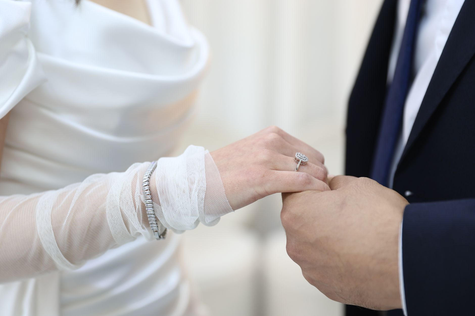 A close-up shot of a bride and groom exchanging wedding rings, symbolizing eternal love.