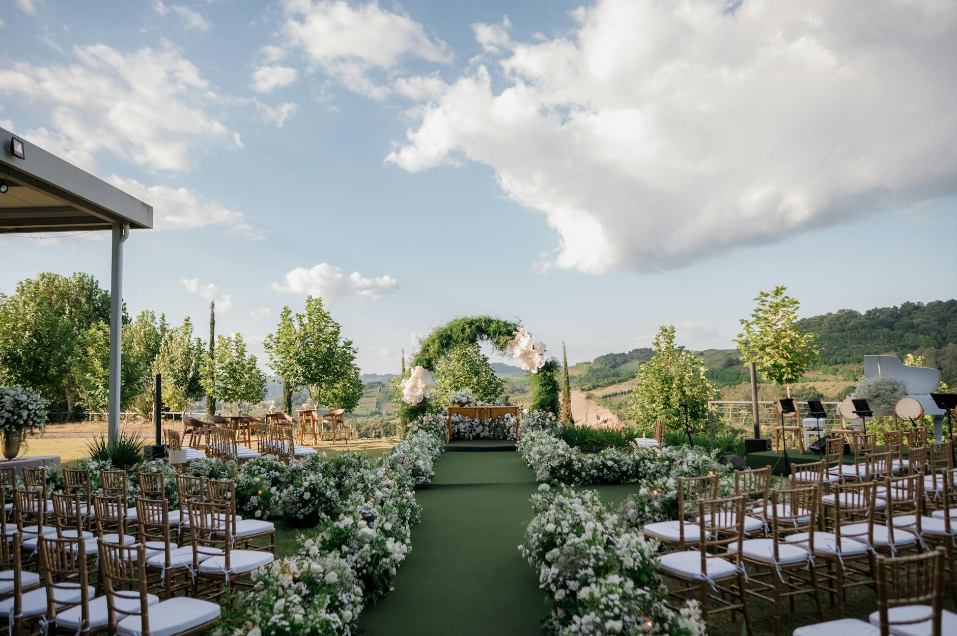 Beautiful outdoor wedding venue with floral decor and scenic landscape.