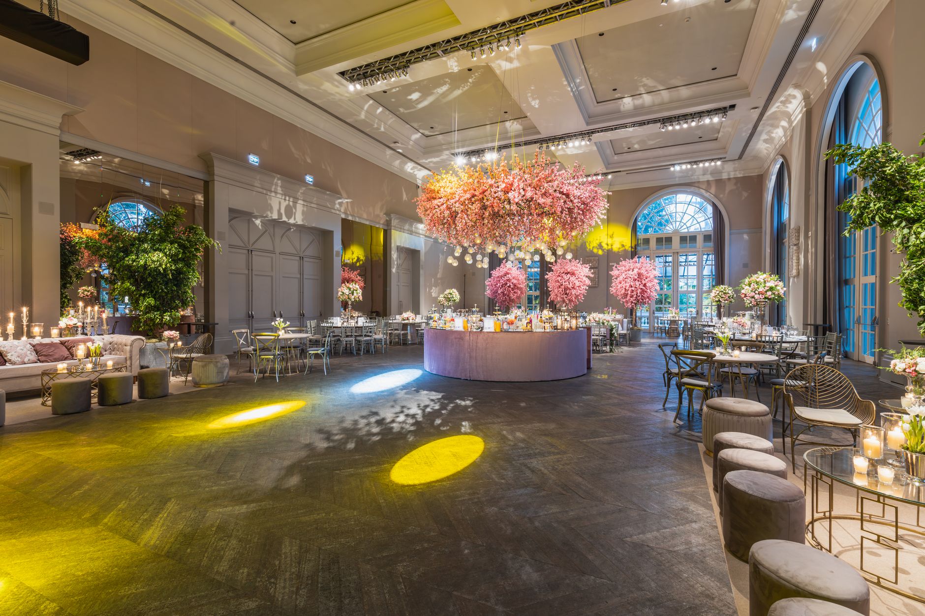 Elegant wedding reception in a luxurious hall with stunning flower arrangements and ambient lighting.