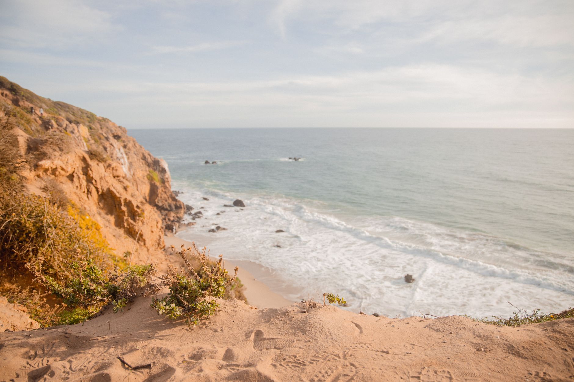 Explore the stunning cliffs and ocean horizon in Malibu on a sunny day.