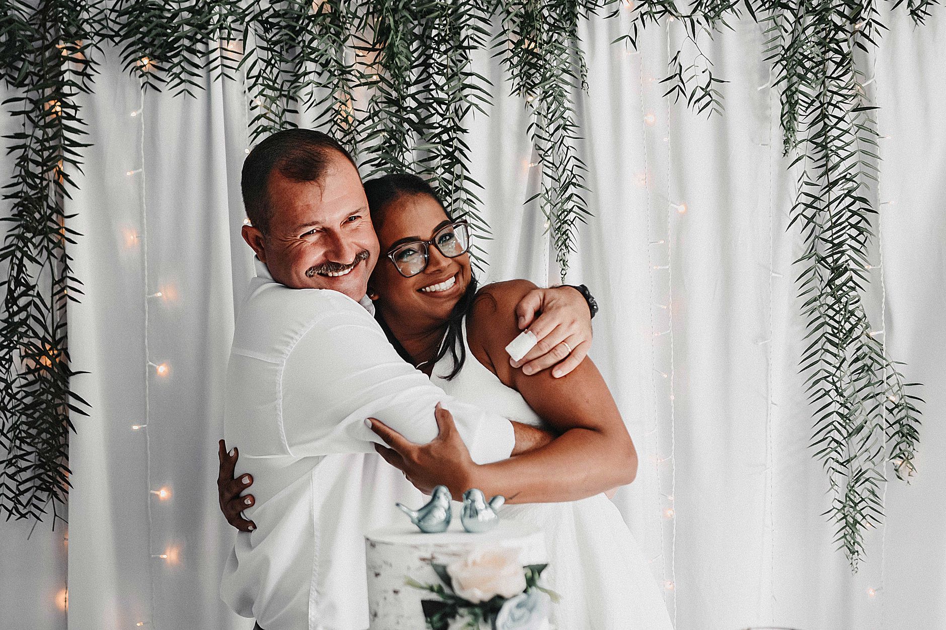 Happy couple embracing at a beautifully decorated wedding reception.
