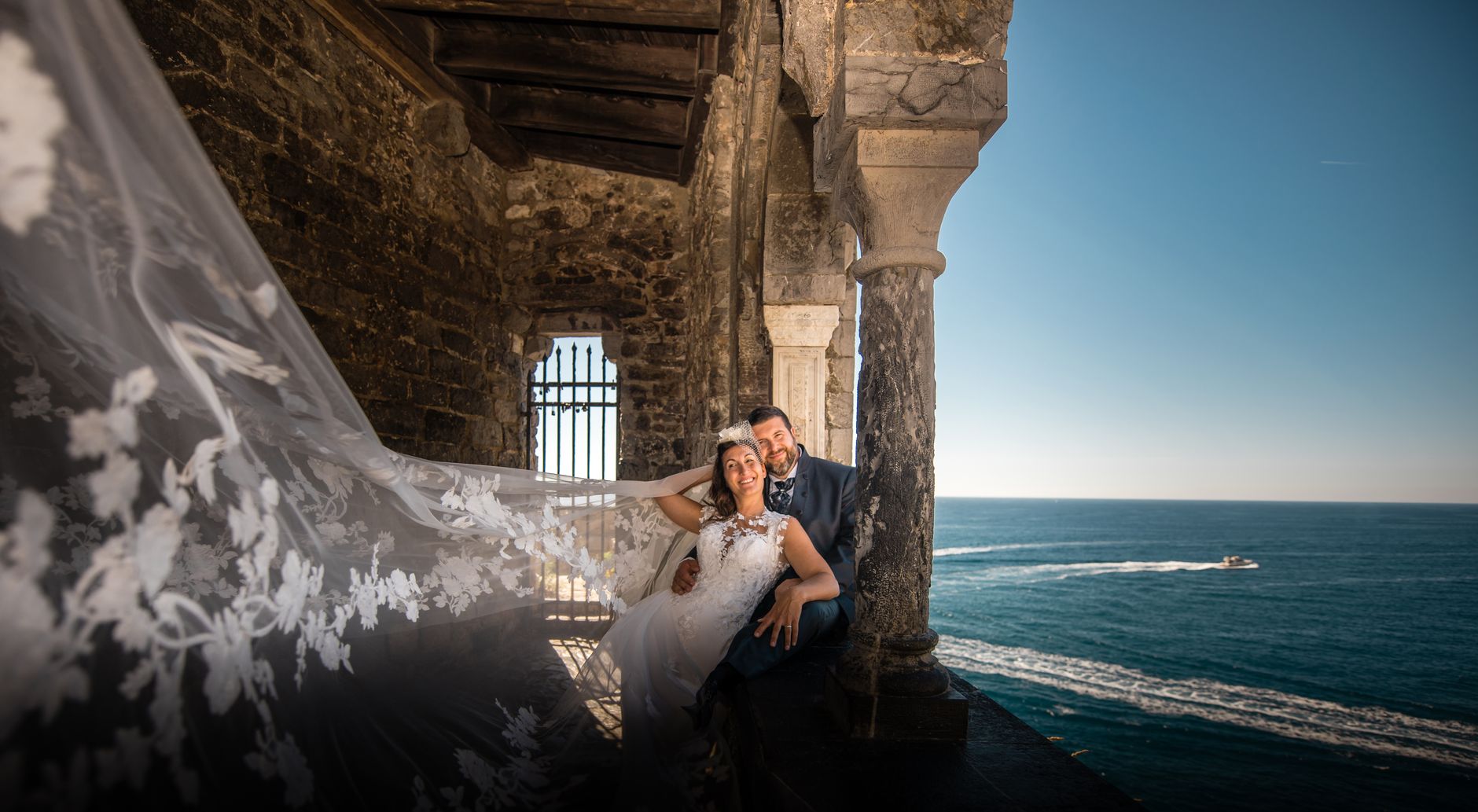 Beautiful wedding portrait of a couple by the sea in Portovenere, Italy.
